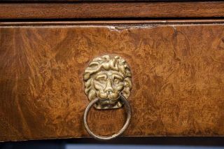 These brass, lion head pulls adorn the drawer fronts. Also note the